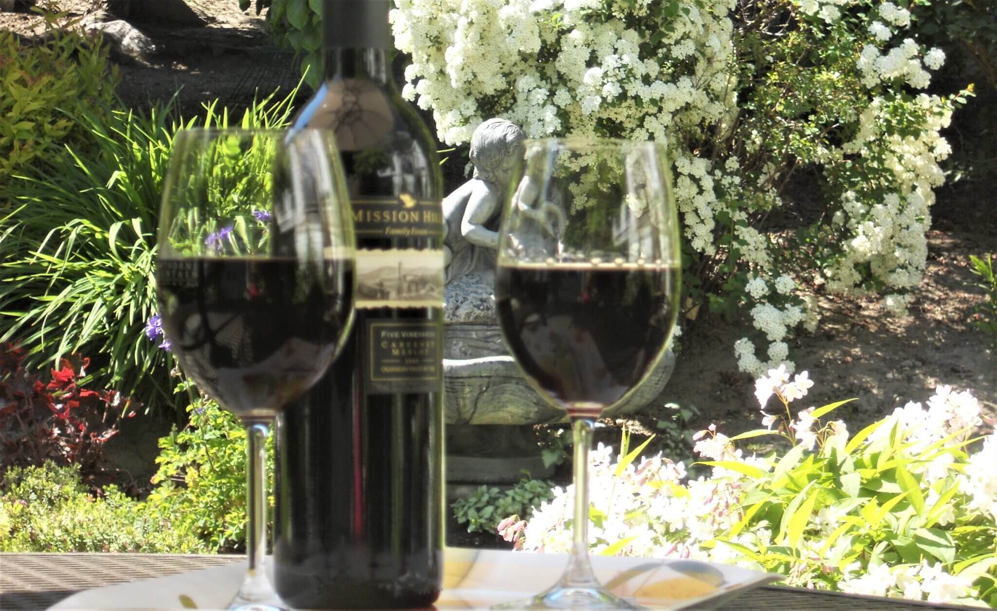 Wine in the garden overlooking a West Kelowna vineyard